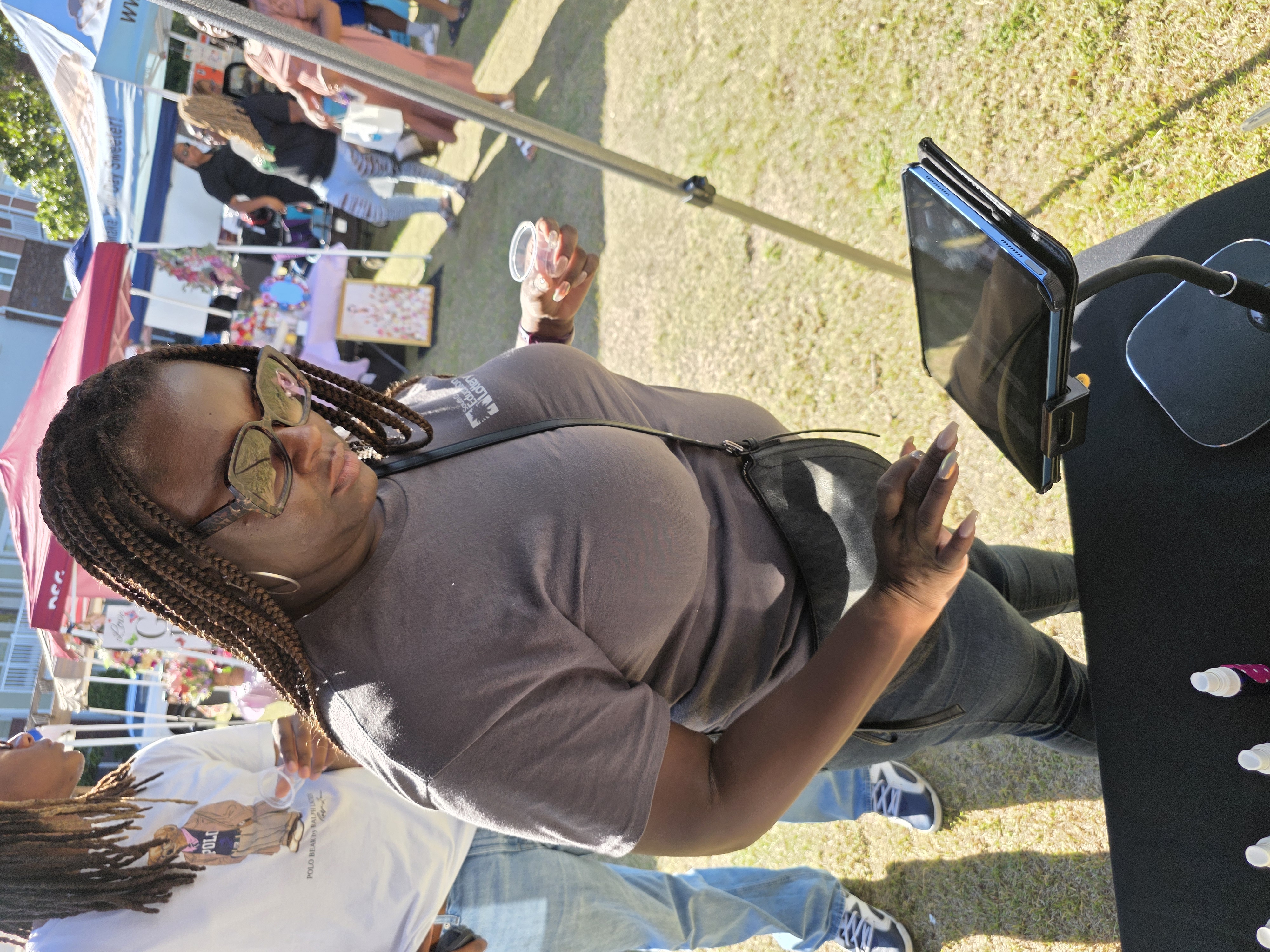 Customer joining the Deeper Than Skin mailing list at the market table